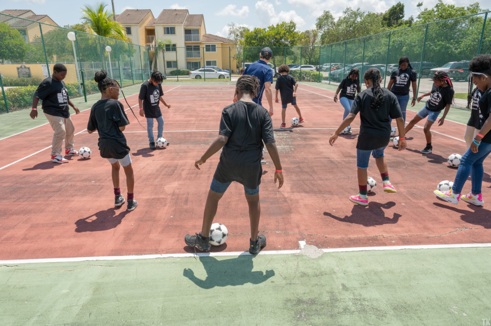 Kids play at the home of a future mini-pitch in Miami
